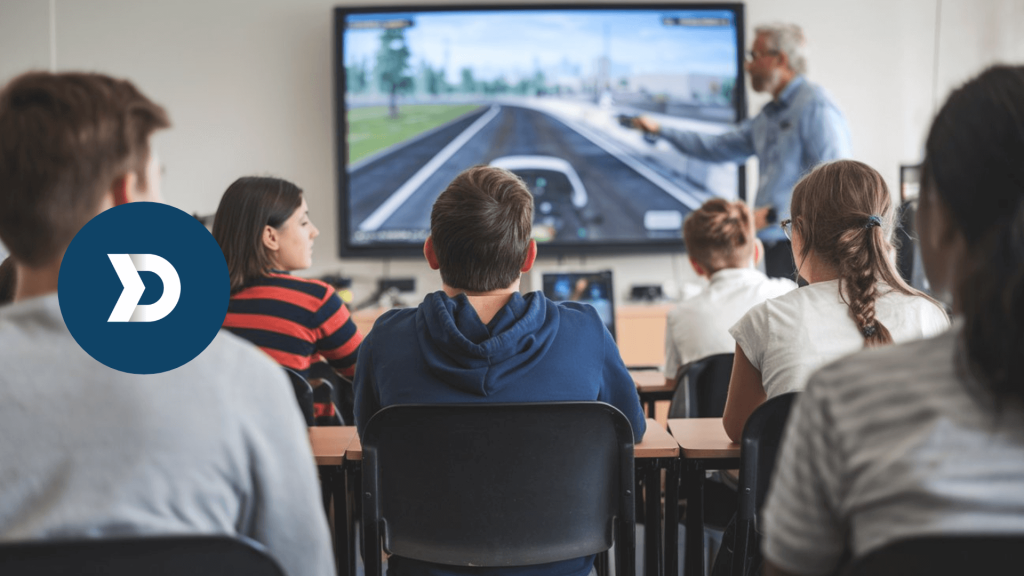 Driving instructor teaching a group of students using a driving simulation on a large screen, emphasizing the role of mobile telematics for driver education and safe driving skills.