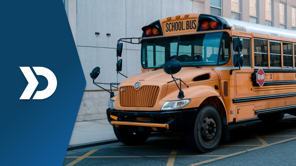 A yellow school bus parked near a school building, symbolizing the role of mobile telematics in improving school transportation safety and efficiency.