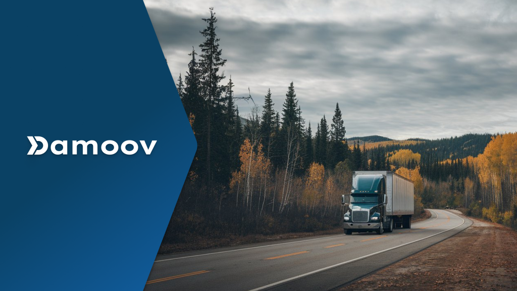 A semi-truck driving on a scenic rural highway surrounded by autumn trees, symbolizing the role of mobile telematics in usage-based leasing models.