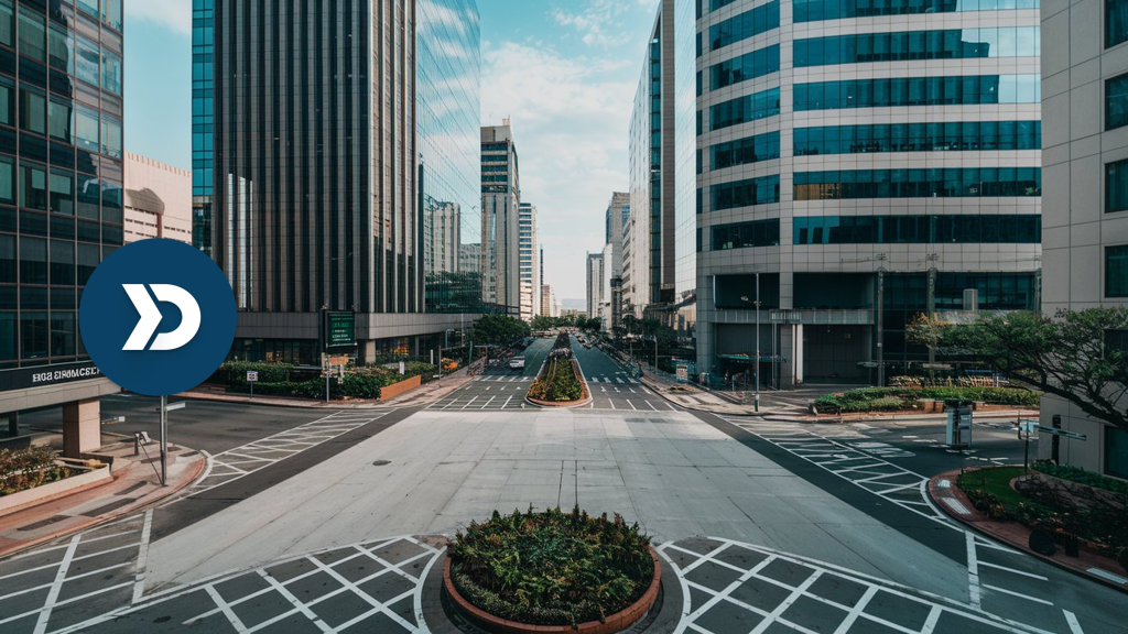 A modern city intersection with high-rise buildings and empty roads, symbolizing how mobile telematics can help reduce traffic congestion and optimize urban mobility.